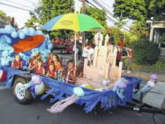 children are riding in the back of a float