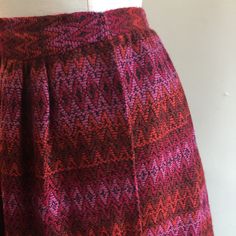 "Kicky little mini skirt in the with the best fabric. Color is a vibrant combination of reds with pink and black. Fits at the waist in wrap style with hook and eye closures. Label is Mr Mort (when it is good it is good!). Condition is Great. Was stored. Measurements (all flat) 13\" waist - about 1\" gain if one wants to move the hook and eyes / 22\" length I'm always happy to provide more information - just send a message! ~~Condition Guide ~~ Mint: Perfect. Possibly never worn. Great: Little vi Red Full Skirt With Elastic Waistband, Red Retro Mini Skirt Skort, Red Fitted Skirt With Elastic Waistband, Red Retro Mini Skort, Retro Red Mini Skort, Red Mini Skirt With Elastic Waistband, Retro Red Skort, Bohemian Red Full Skirt, Retro Red Mini Skirt