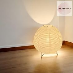 a white lamp sitting on top of a wooden floor