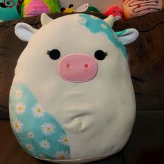 a stuffed cow sitting on top of a couch