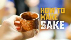 a person holding a coffee cup with the words how to make sake