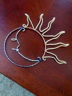 two bracelets sitting on top of a wooden table next to an orange and white object