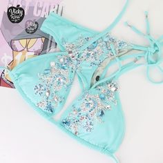 "Oh, what a bright and stylish bikini! This Turquoise Designer Swimwear will be your perfect decoration and complement! The incredible brilliance of the crystals of this bikini will cover the whole audience. Excellent tailoring will give confidence combined with a beautiful bikini stage look. So everyone will be Amazed by the beauty of your Crystal Bikini! ❤ Fully lined ❤ Adjustable drawstring triangle top with push up ❤ Beautiful sparkle appearance ❤ Hand-applied crystals ❤ Spandex material ❤ H Turquoise Halter Neck Swimwear For Swimming, Turquoise Halter Neck Swimwear For Poolside, Turquoise Triangle Top Beachwear, Triangle Top Swimwear For Beach Party, Triangle Top Swimwear For Beach Season Party, Turquoise Triangle Top Swimwear For Party, Party Triangle Top Swimwear For Beach Season, Fitted Turquoise Swimwear For Beachwear, Turquoise Fitted Halter Neck Swimwear