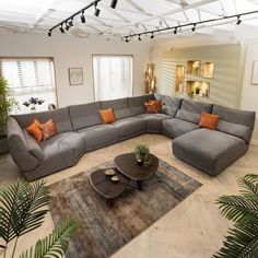 a living room filled with furniture and plants