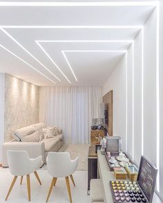 a living room filled with furniture and white walls