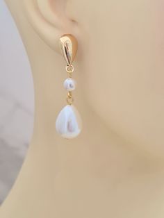 Introducing these gorgeous shell coated pearl drop earrings with gold plated teardrop studs.  Elegant and suitable for your special occasion. These earrings measure just over 1.5in/4.2cm. The earrings will arrive in a bag ready for giving. This item ships from the UK within 1 working day. White Drop Earrings With Pearl Pendant, Gold Dangle Drop Earrings For Wedding, Anniversary Teardrop Pearl Chain Earrings, Anniversary Drop Earrings With Pearl Charm, Teardrop Pearl Chain Earrings For Anniversary, Elegant Gold Drop Earrings For Wedding, White Teardrop Earrings With Pearl Charm For Formal Occasions, Pearl Drop Clip-on Earrings, Pearl White Drop Pearl Earrings For Pierced Ears