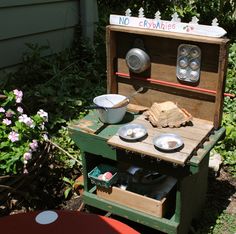 an old fashioned wooden stove with pots and pans on it's burner