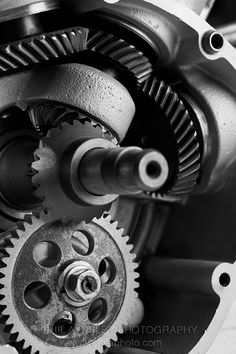 black and white photograph of an old motorcycle engine with the gears still attached to it