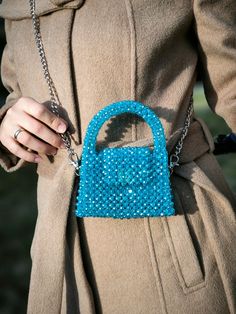 This hand-knitted children's bag stands out with its elegant shades of blue and unique craftsmanship. Each detail of this bag is meticulously crafted, resembling a small piece of art. The bright blue crystal accents create a playful sparkle on the bag, while the knitted texture adds warmth and character. Designed for children, this bag combines style and practicality. Its spacious interior allows for easy organization of daily essentials, while its sturdy knitted structure ensures long-lasting u Blue Shoulder Bag With Mobile Phone Pocket For Party, Blue Party Shoulder Bag With Mobile Phone Holder, Blue Handmade Evening Bag For Everyday Use, Blue Crossbody Evening Bag As Gift, Blue Crossbody Evening Bag For Gifts, Blue Mobile Phone Evening Bag, Trendy Handmade Blue Bags, Trendy Blue Shoulder Bag For Gift, Trendy Blue Crochet Tote Bag