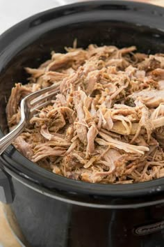 a slow cooker filled with shredded meat