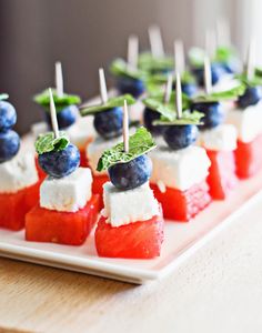 watermelon and blueberries on skewers with mint garnish