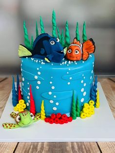 a blue cake with fish and seaweed on it