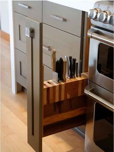 a kitchen with an oven, microwave and cutting board