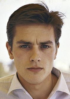 a close up of a person wearing a shirt and tie with his hair in the air