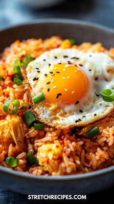 an egg on top of rice in a bowl