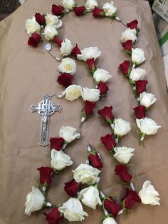 flowers laid out on a table with a crucifix