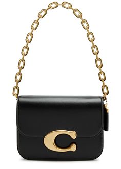 Find COACH Idol Leather Shoulder Bag on Editorialist. The Coach Idol Leather Shoulder Bag features a detachable chain shoulder strap, a detachable adjustable leather shoulder strap, a designer plaque, and a detachable hanging designer tag on the side. It includes a back slip pocket, two compartments, a concealed press-stud fastening pocket at the front flap, an internal zip-fastening pocket, and a fully lined interior. It features a concealed magnetic fastening at the front flap. The bag measures 8 inches in width, 6 inches in height, and 2.5 inches in depth. The chain shoulder strap has a drop of 9.5 inches. The leather shoulder strap has a minimum drop of 19.5 inches and a maximum drop of 23.5 inches. Coach Leather, Press Studs, Leather Shoulder Bag, 6 Inches, Women's Accessories, Bag Accessories, Shoulder Strap, Bag Lady, Shoulder Bag