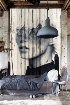 a bedroom with a painting on the wall next to a bed