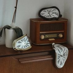 an old fashioned radio sitting on top of a wooden shelf next to a pair of slippers