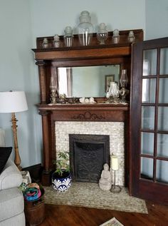 a living room with a fireplace and mirror