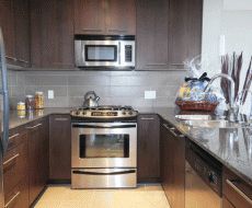 a kitchen with stainless steel appliances and granite counter tops