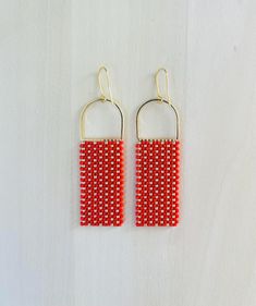 Red and Gold glass bead statement earrings inspired by a baltic basket weave motif. The beads sparkle beautifully in the light accentuating the basket weave pattern. Each bead is hand sown row after row. Glass beads reveal a beautiful shine as they catch the light. Could be worn daily or on a special occasion. Lightweight and sturdy design! Make a statement with these handmade bead earrings with a modern and bold design.  Minimalist with a pop of color to brighten up any outfit or occasion. 14K Basket Weave Pattern, Tiny Studio, Weave Pattern, Design Minimalist, Gold Glass, Basket Weave, Handmade Beads, Bead Earrings, Red And Gold