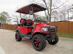 a red golf cart parked on the street