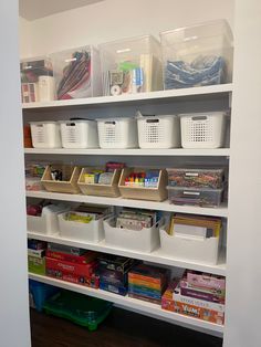 the shelves are organized with bins, baskets and other items to keep things organized