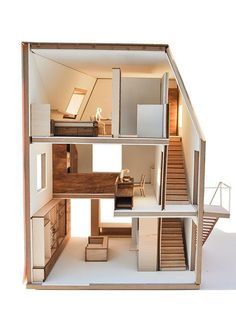 a doll house with stairs and furniture inside