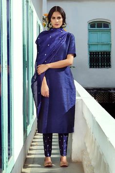 Blue raw silk straight kurta with round neck and pure silk piping details. Paired with straight fit pant with all over floral butti pattern, metallic sequin, zari hand embroidery and handwoven organza silk dupatta with pure silk border.
Components: 3
Pattern: Hand Embroidered
Type Of Work: Sequin and Zari Work
Neckline: Round
Sleeve Type: Half Sleeves
Fabric: Raw Silk, Dupatta: Handwoven Organza Silk
Color: Blue
Other Details: 
Embroidered dupatta
Closure:
Kurta: Front concealed placket
Pant: Ha Vs Image, Silk Pant, Pakistani Suit, Kurta Set For Women, Straight Fit Pants, Embroidered Pants, Indian Dress, Zari Work, Organza Dupatta