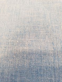 closeup of blue fabric textured with small white dots on the top and bottom