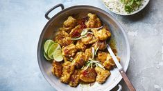 a bowl filled with chicken and vegetables next to rice