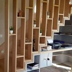 an office with wooden shelves and bookshelves on the wall next to a computer desk