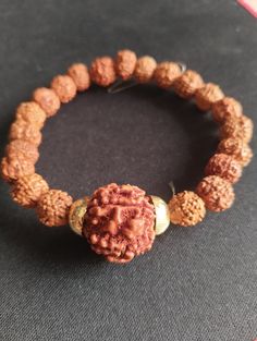 Rudraksha Wrist Bracelet Stretchable with Large Rudraksha Guru Bead Energized A Rudraksha wrist bracelet with a stretchable design and a large Rudraksha guru bead is a popular accessory in spiritual and holistic practices. Here are some key points about such bracelets: Stretchable Design: The stretchable feature makes the bracelet easy to wear and remove, providing comfort and flexibility for different wrist sizes. Large Rudraksha Guru Bead: The guru bead, often larger than the other beads in the bracelet, typically serves as a focal point for meditation and prayer. It's considered significant in many spiritual traditions. Energized: The term "energized" suggests that the bracelet may have undergone a ritual or ceremony to imbue it with spiritual energy or blessings. This is a common pract Adjustable Beaded Bracelets For Rituals, Spiritual Brown Bracelet For Rituals, Spiritual Hand-strung Beaded Bracelets For Rituals, Adjustable Bracelets For Meditation And Festivals, Festive Adjustable 8mm Beaded Jewelry, Adjustable Spiritual Bracelets For Festivals, Spiritual Beaded Wristband Bangle, Spiritual Beaded Bangle Bracelets For Festivals, Hand-strung Brown Spiritual Stretch Bracelet