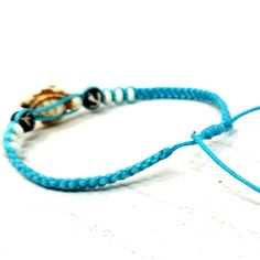 "Handmade Turtle Bracelet perfect for any occasion, the perfect gift, satisfaction guaranteed. Materials: Turquoise Turtle Bead, Black Durable Cord and White Beads. Handmade Turtle Bracelet with Blue Cord, Blue Turtle Beads, Silver Tone Starfish and Clear Beads. Handmade Blue Macrame Bracelet perfect for any occasion, the perfect gift, satisfaction guaranteed. Fast Shipping! Visit my Etsy Shop to see more Handmade Starfish and Turtle Jewelry! https://www.etsy.com/shop/TheArtisansHall At Artisans Handmade Adjustable Turtle Bracelet, Adjustable Turtle Bracelet For Beach, Adjustable Round Bracelets For Beach, Adjustable Round Bracelets For The Beach, Turtle Anklet, Blue Macrame, Blue Turtle, Hemp Bracelet, Turtle Jewelry