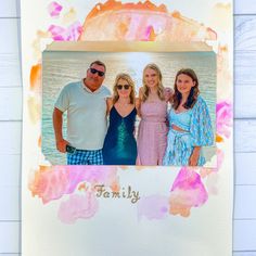 three people are posing for a photo in front of watercolor stains and the words family