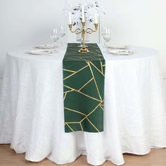 the table is set with white and green linens