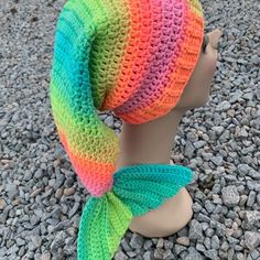 a crocheted hat with a fish tail on top of a mannequin head