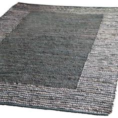 an area rug with grey and white stripes on the bottom, in front of a white background