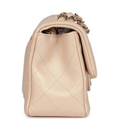 This Chanel mini classic rectangular flap bag is of iridescent beige lambskin leather with light gold tone hardware and has a front flap with signature CC turnlock closure, rear half moon pocket, single interwoven iridescent beige leather and light gold chain link shoulder/crossbody strap.The interior is lined in iridescent beige leather and features a zipper pocket with Chanel pull and an open pocket below.Collection: 22C (RFID Chip)Origin: FranceCondition: New and never worn (plastic on hardware)Accompanied by: Chanel box (damaged), Chanel dustbag, felt and COA cardMeasurements: 8" width x 5" height x 2.5" depth; 20" strap drop Elegant Beige Flap Bag With Cc Turnlock Closure, Luxury Beige Flap Bag With Cc Turnlock Closure, Luxury Beige Double Flap Bag, Luxury Beige Flap Bag, Beige Rectangular Flap Bag With Cc Turnlock Closure, Beige Double Flap Leather Bag, Luxury Beige Double Flap Shoulder Bag, Elegant Beige Flap Bag, Beige Formal Flap Bag