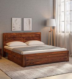 a bed sitting in a bedroom on top of a wooden floor next to a window