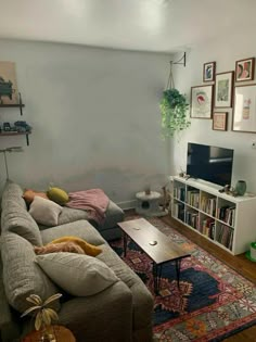 a living room filled with furniture and a flat screen tv on top of a wooden table