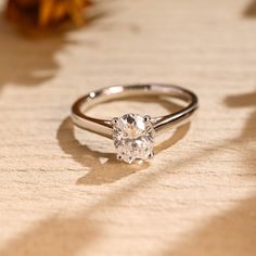 a diamond ring sitting on top of a wooden table