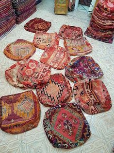 many rugs and pillows are on the floor