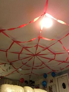 the ceiling is decorated with red ribbon and balloons