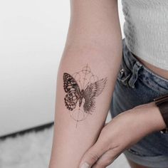 a woman with a butterfly tattoo on her arm