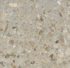 a close up view of the surface of a marbled floor with small rocks on it