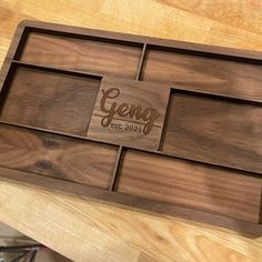 a wooden tray with the word geng engraved on it