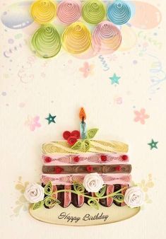 a birthday card with a large cake on it's side, surrounded by paper flowers