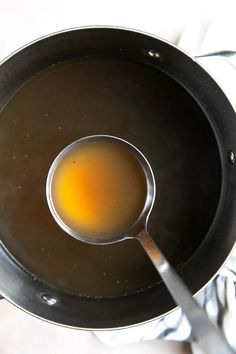 an egg is being cooked in a frying pan on top of a white cloth